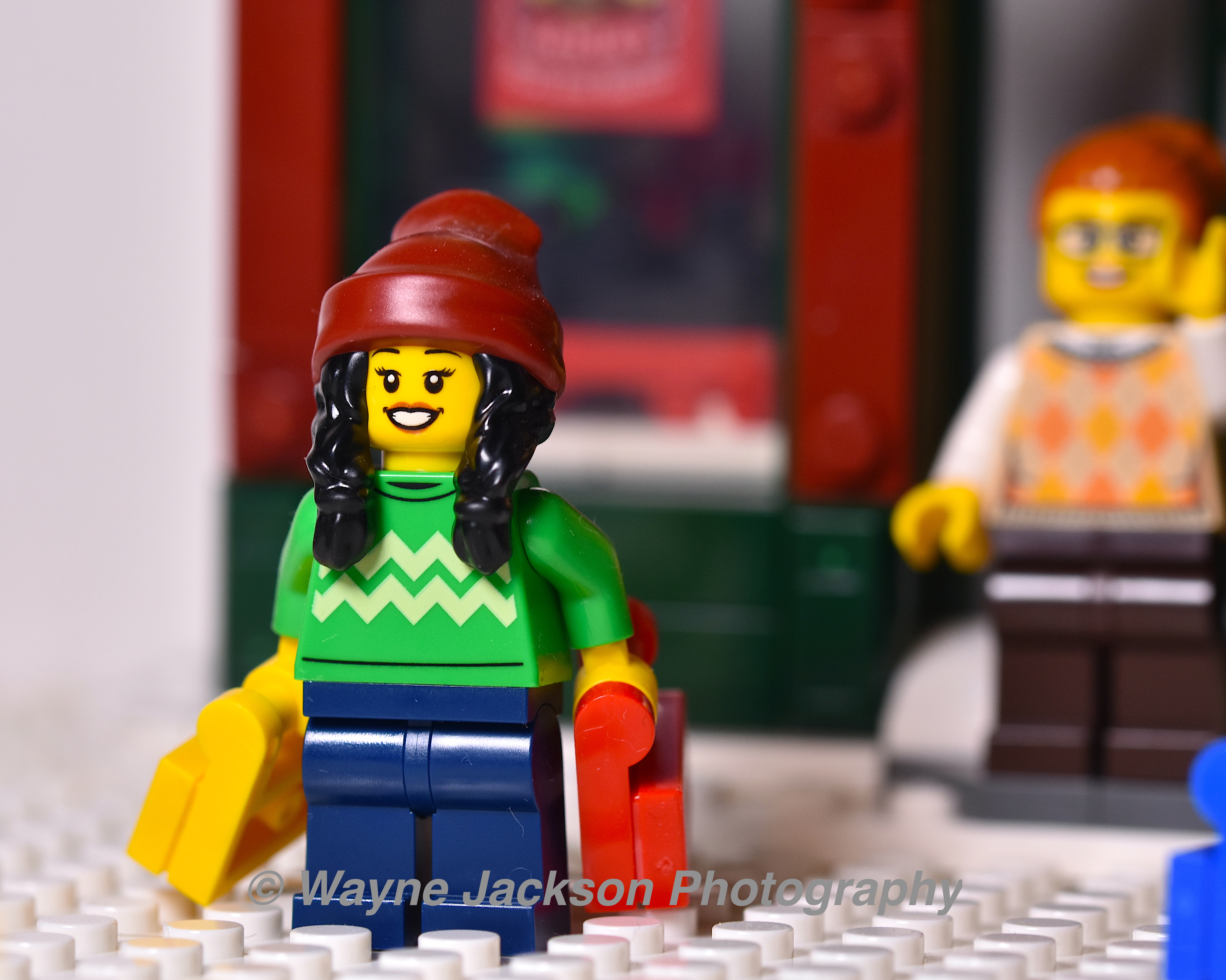 A woman Lego minifigure from the Holiday Main Street set 10308