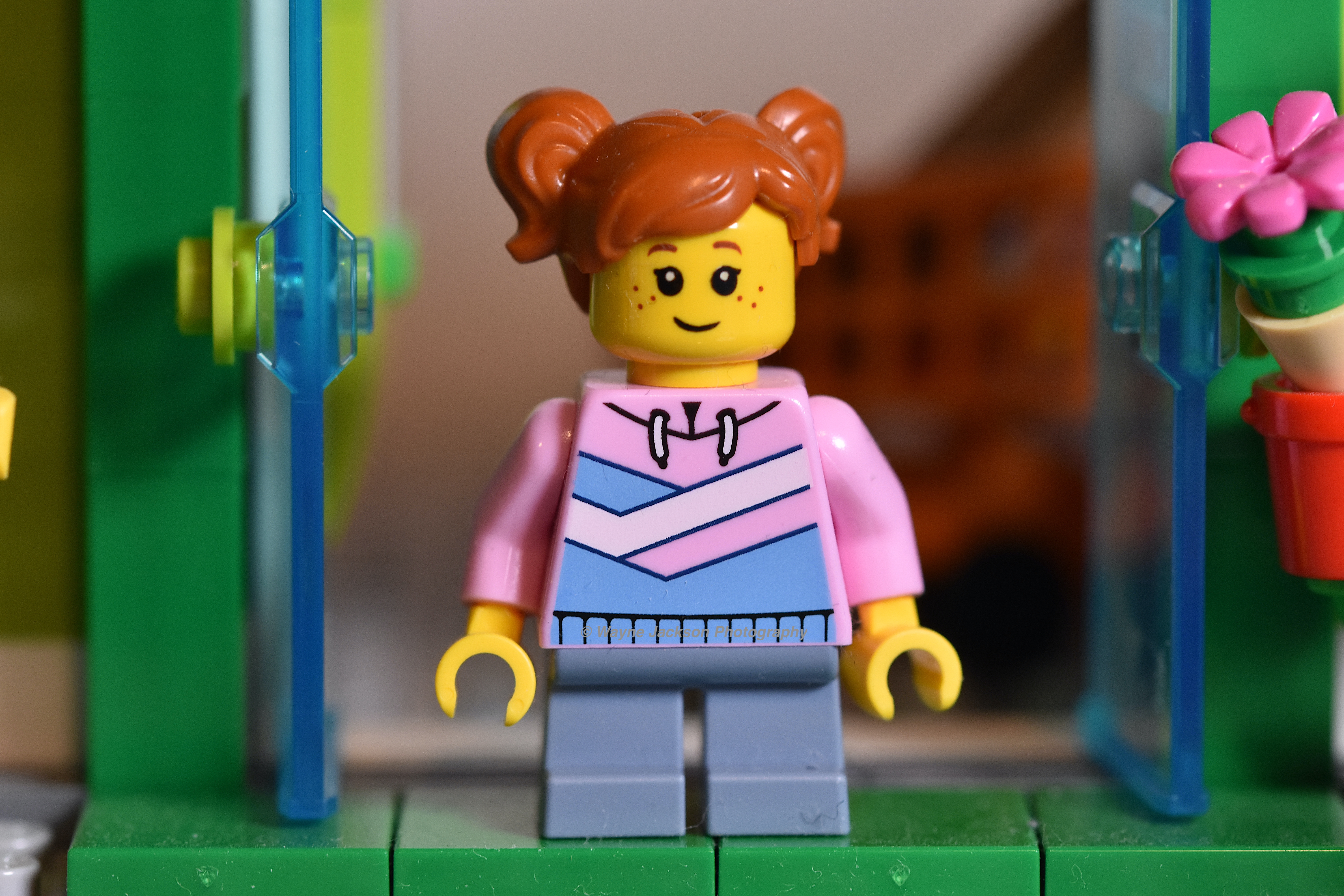 A female Lego minifigure from the Grocery Store set 60347 with dust on